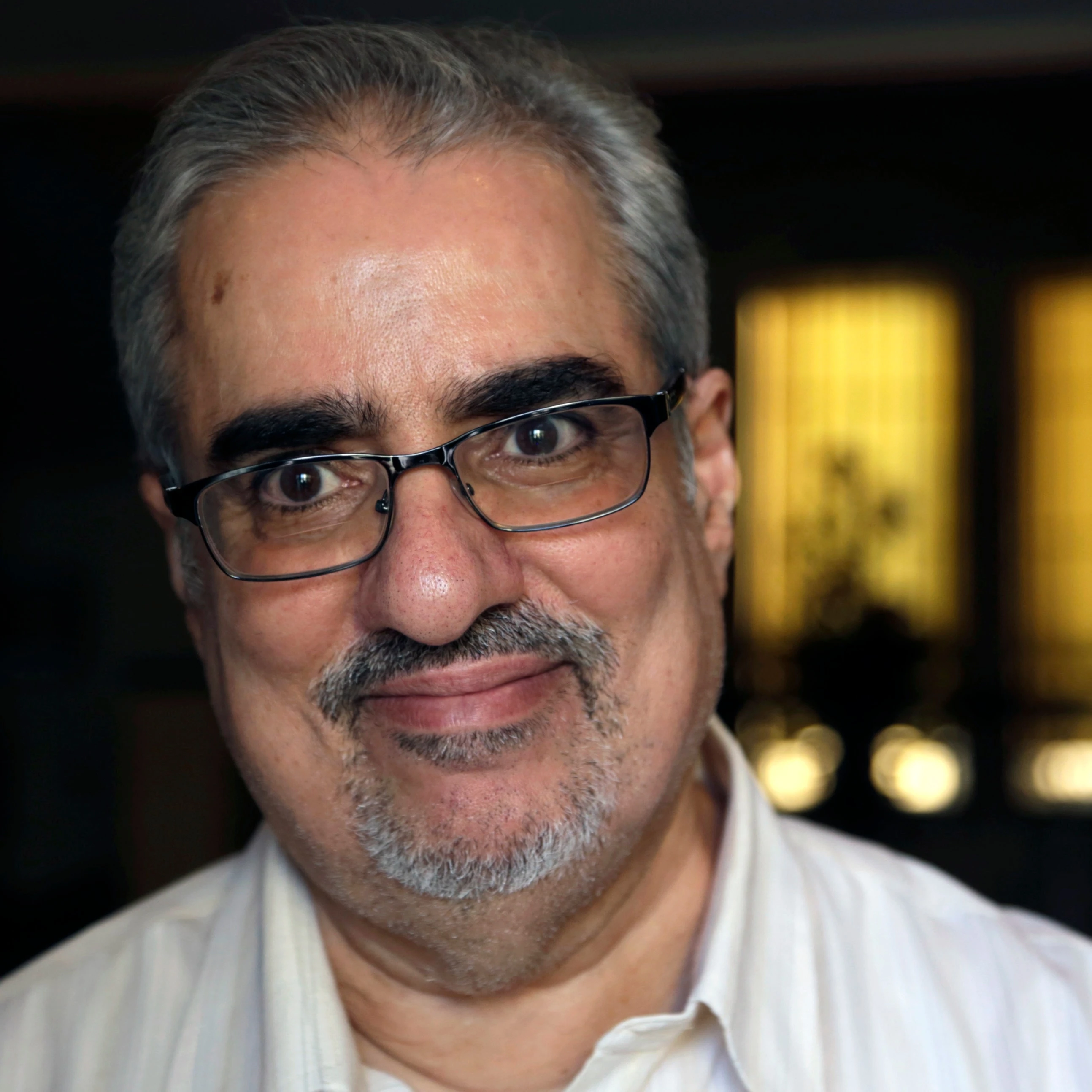 Bahraini Sunni Muslim opposition leader Ibrahim Sharif, who led the opposition National Democratic Action Society group, smiles to journalists at his home following his overnight release from prison, in Tubli, Bahrain, Saturday, June 20, 2015 (AP)
