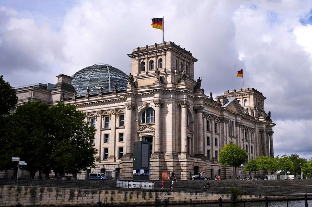 German national flags wave on top of the Reichstag Building, the house of the German parliament Bundestag during a debate about the budget 2025, in Berlin, Germany, Tuesday, July 8, 2025. (AP)