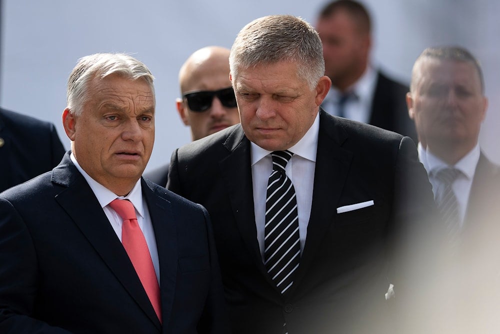 Hungary's Prime Minister Viktor Orban, and his Slovakian counterpart Robert Fico talk before delivering speeches during the 130th anniversary celebration of Mária Valeria Bridge in Esztergom, Hungary, on Sunday, Sept. 28, 2025 (AP)