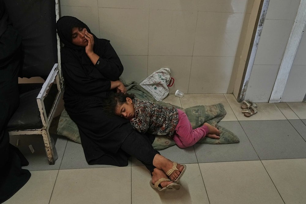 Palestinian children and their families rest in the corridors due to overcrowding in the pediatric department at Nasser Hospital in Khan Younis, southern Gaza Strip, Wednesday, Oct. 8, 2025 (AP)