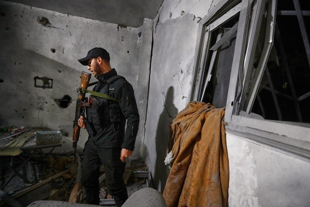 A Syrian Internal Security Forces officer inspects a home in Damascus, Syria, Friday, November 14, 2025, after it was hit by rockets (AP)