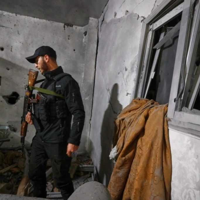 A Syrian Internal Security Forces officer inspects a home in Damascus, Syria, Friday, November 14, 2025, after it was hit by rockets (AP)