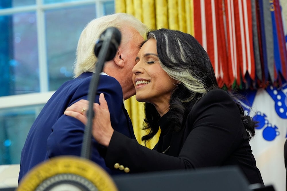 President Donald Trump congratulates Tulsi Gabbard after she was sworn in as the Director of National Intelligence in the Oval Office of the White House, Wednesday, Feb. 12, 2025, in Washington (AP)