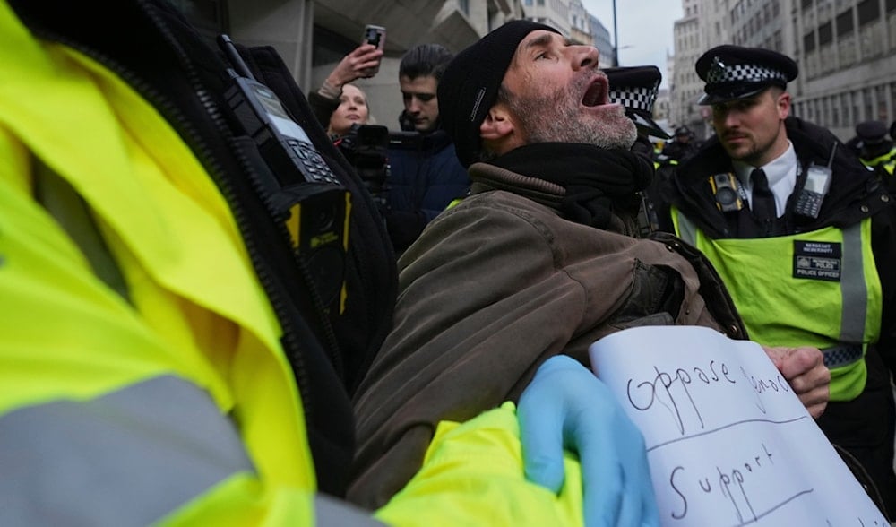 Police arrest a protester outside the Ministry of Justice during a Palestine Action demonstration in London, Thursday, Nov. 20, 2025. (AP)