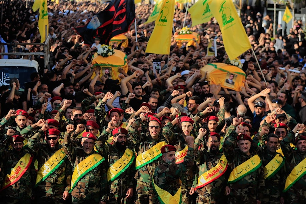 Hezbollah fighters raise their fists and chant slogans as they march in the funeral procession of five comrades killed in Israeli strikes in recent days, in the southern town of Nabatieh, Lebanon, Sunday, Nov. 2, 2025. (AP)