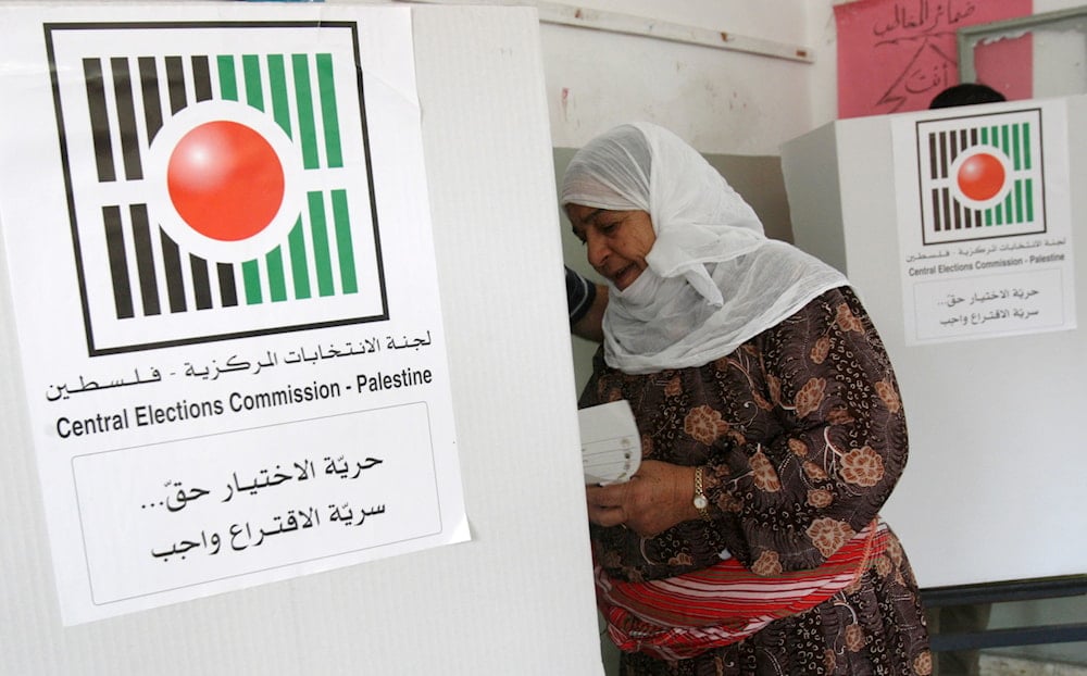 A Palestinian woman prepares to vote in municipal elections at a polling station in the West Bank city of Nablus, Saturday, Oct. 20, 2012 (AP)