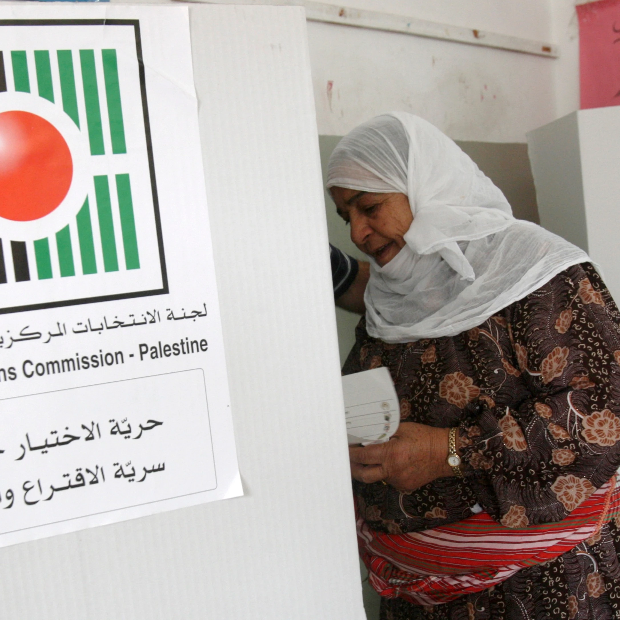 A Palestinian woman prepares to vote in municipal elections at a polling station in the West Bank city of Nablus, Saturday, Oct. 20, 2012 (AP)