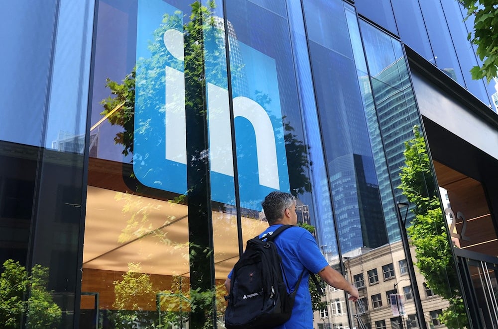 A pedestrian walks by a sign at a LinkedIn office on July 26, 2023 in San Francisco, California. (AFP)