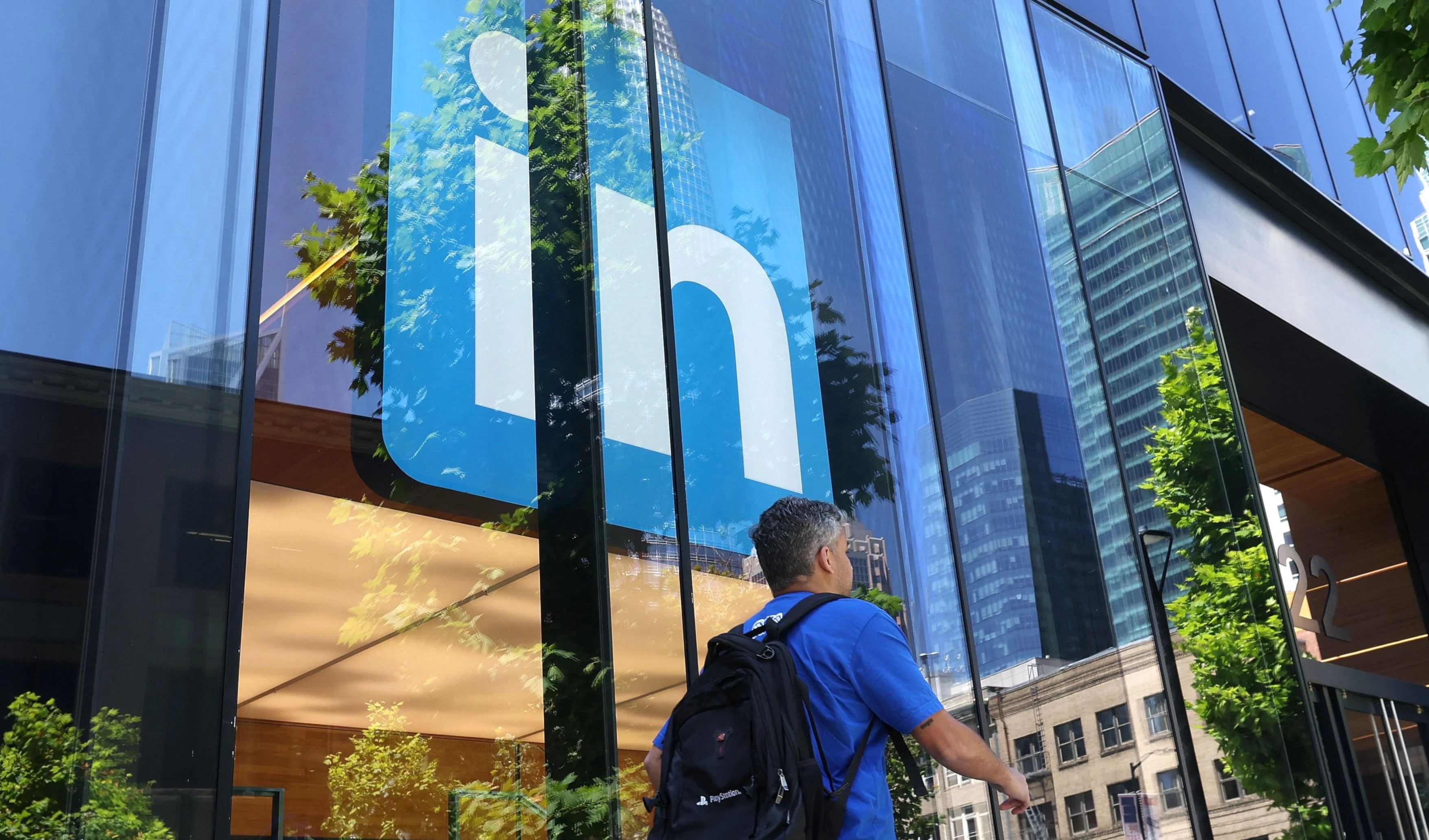 A pedestrian walks by a sign at a LinkedIn office on July 26, 2023 in San Francisco, California. (AFP)