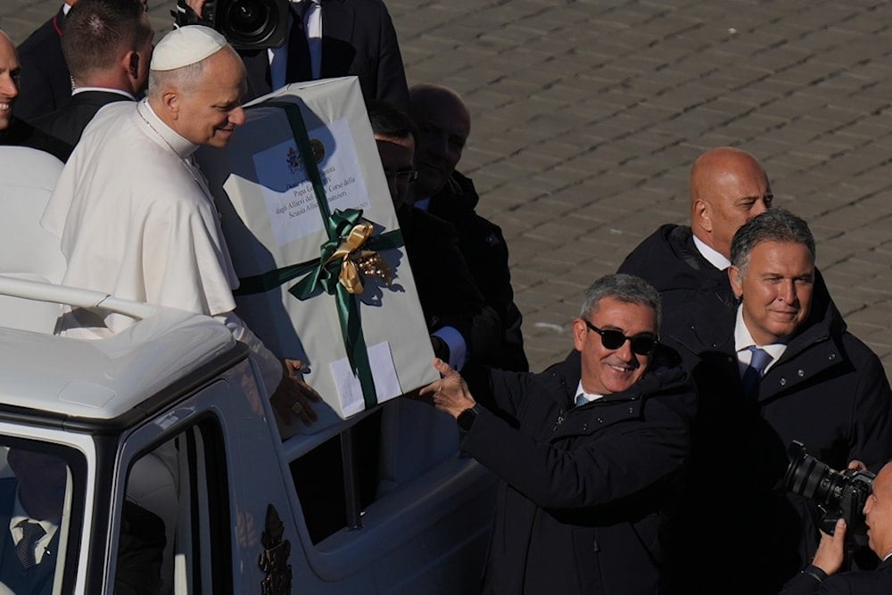 Pope Leo XIV receives a present as he leaves after celebrating a Mass for the Jubilee of the Choirs in St. Peter's Square, at the Vatican, Sunday, November 23, 2025 (AP)