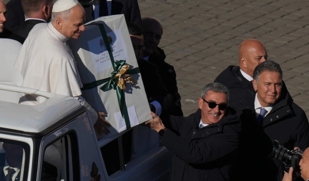 Pope Leo XIV receives a present as he leaves after celebrating a Mass for the Jubilee of the Choirs in St. Peter's Square, at the Vatican, Sunday, November 23, 2025 (AP)