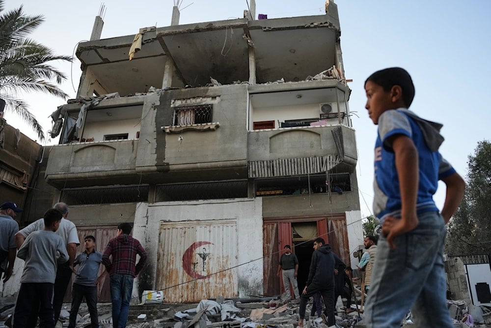 Palestinians inspect the damage to a house targeted by an Israeli strike in Deir al-Balah, in the central Gaza Strip, Saturday, November 22, 2025 (AP)