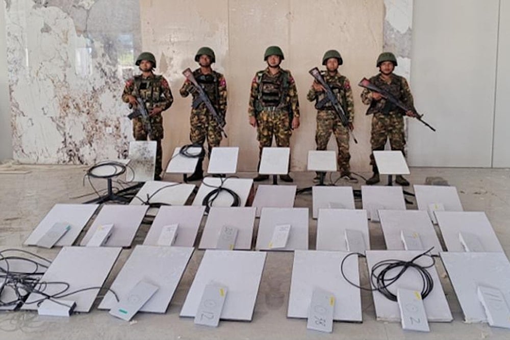 In this image provided by the Myanmar military on Oct. 19, 2025, soldiers stand next to Starlink machines as they seize KK Park online scam center in Myawaddy township, Karen State, Myanmar (AP)