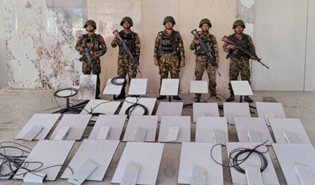 In this image provided by the Myanmar military on Oct. 19, 2025, soldiers stand next to Starlink machines as they seize KK Park online scam center in Myawaddy township, Karen State, Myanmar (AP)