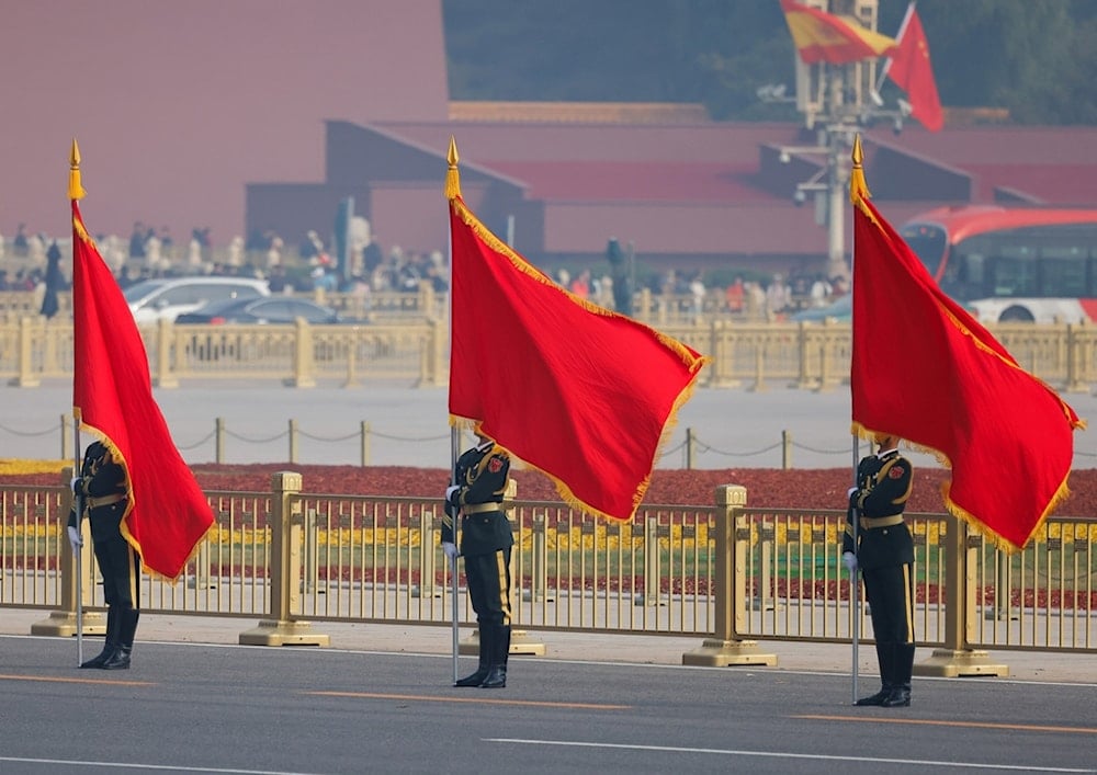 Chinese People's Liberation Army (PLA) honour guard members hold flags during a welcoming ceremony at the Great Hall of the People in Beijing Wednesday, Nov. 12, 2025. (AP)