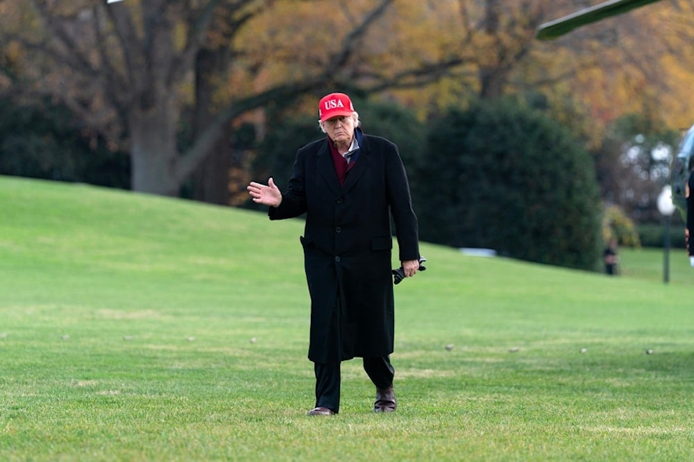 US President Donald Trump waves to the media as he walks in the South Lawn upon his arrival to the White House, Saturday, November 22, 2025, in Washington. (AP Photo/Jose Luis Magana)