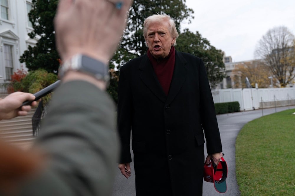 President Donald Trump talks to reporters as he departs from the South Lawn of the White House, Saturday, Nov. 22, 2025, in Washington, en route to Joint Base Andrews. (AP Photo/Jose Luis Magana)