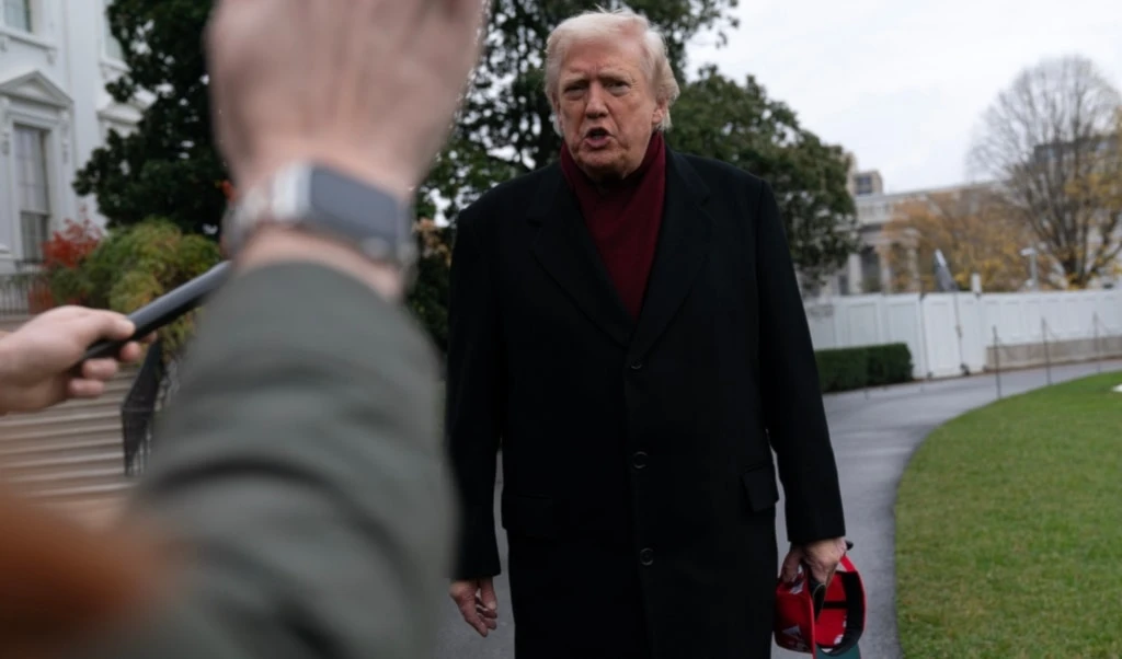 President Donald Trump talks to reporters as he departs from the South Lawn of the White House, Saturday, Nov. 22, 2025, in Washington, en route to Joint Base Andrews. (AP Photo/Jose Luis Magana)