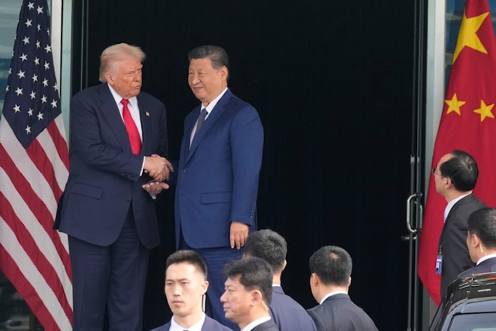 US President Donald Trump, left, and Chinese President Xi Jinping, right, shake hands after their U.S.-China summit meeting at Gimhae International Airport Jinping in Busan, South Korea, Thursday, October 30, 2025. (AP Photo/Mark Schiefelbein)