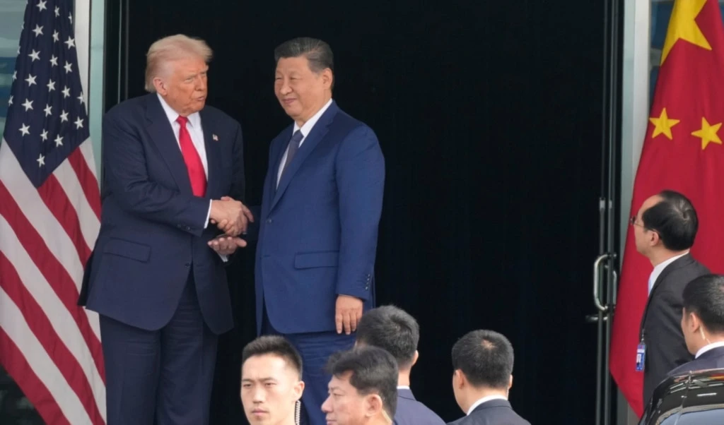 US President Donald Trump, left, and Chinese President Xi Jinping, right, shake hands after their U.S.-China summit meeting at Gimhae International Airport Jinping in Busan, South Korea, Thursday, October 30, 2025. (AP Photo/Mark Schiefelbein)