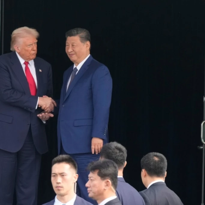 US President Donald Trump, left, and Chinese President Xi Jinping, right, shake hands after their U.S.-China summit meeting at Gimhae International Airport Jinping in Busan, South Korea, Thursday, October 30, 2025. (AP Photo/Mark Schiefelbein)