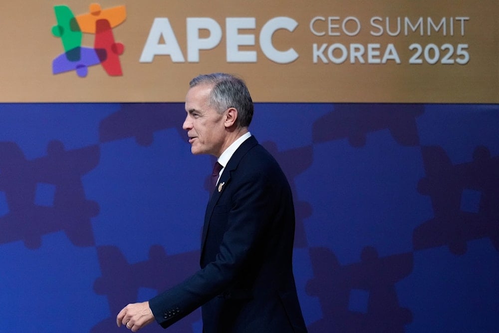 Canadian Prime Minister Mark Carney walks to the podium to make a keynote speech at the Asia-Pacific Economic Cooperation (APEC) CEO summit in Gyeongju, South Korea, Friday, October 31, 2025. (AP Photo/Ng Han Guan)