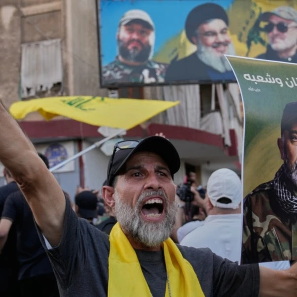 A Lebanese citizen shouts slogans as he carries a portrait of Hezbollah's Chief of Staff Haitham Tabtabai during his funeral procession in the southern suburb of Beirut, Lebanon, Nov. 24, 2025. (AP)