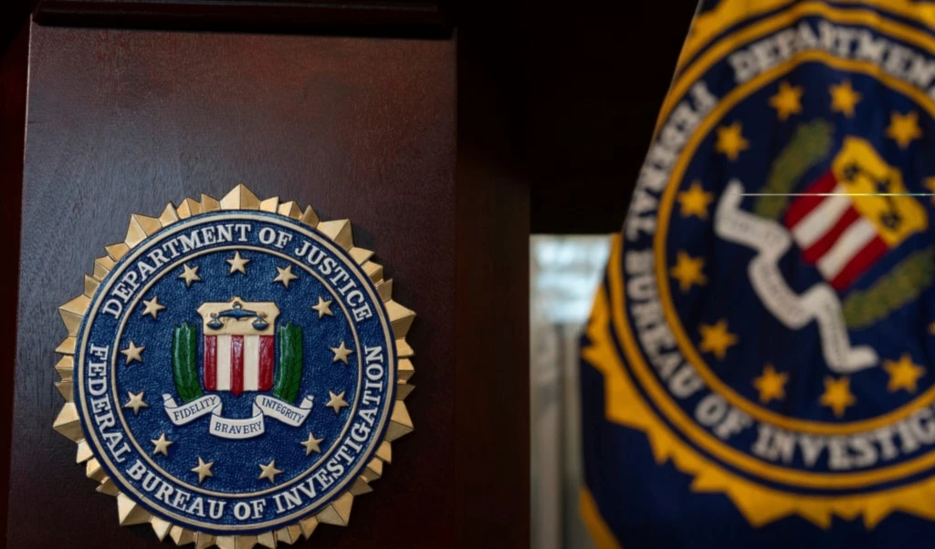 An FBI seal is displayed on a podium before a news conference at the field office in Portland, Ore., Thursday, Jan. 16, 2025. (AP Photo/Jenny Kane)