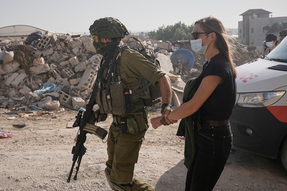 Israeli soldiers detain a demonstrator during a protest calling for the return of forcibly displaced Palestinians to their homes in the Nur Shams refugee camp, in the West Bank city of Tulkarem, Sunday, Nov. 23, 2025. (AP)