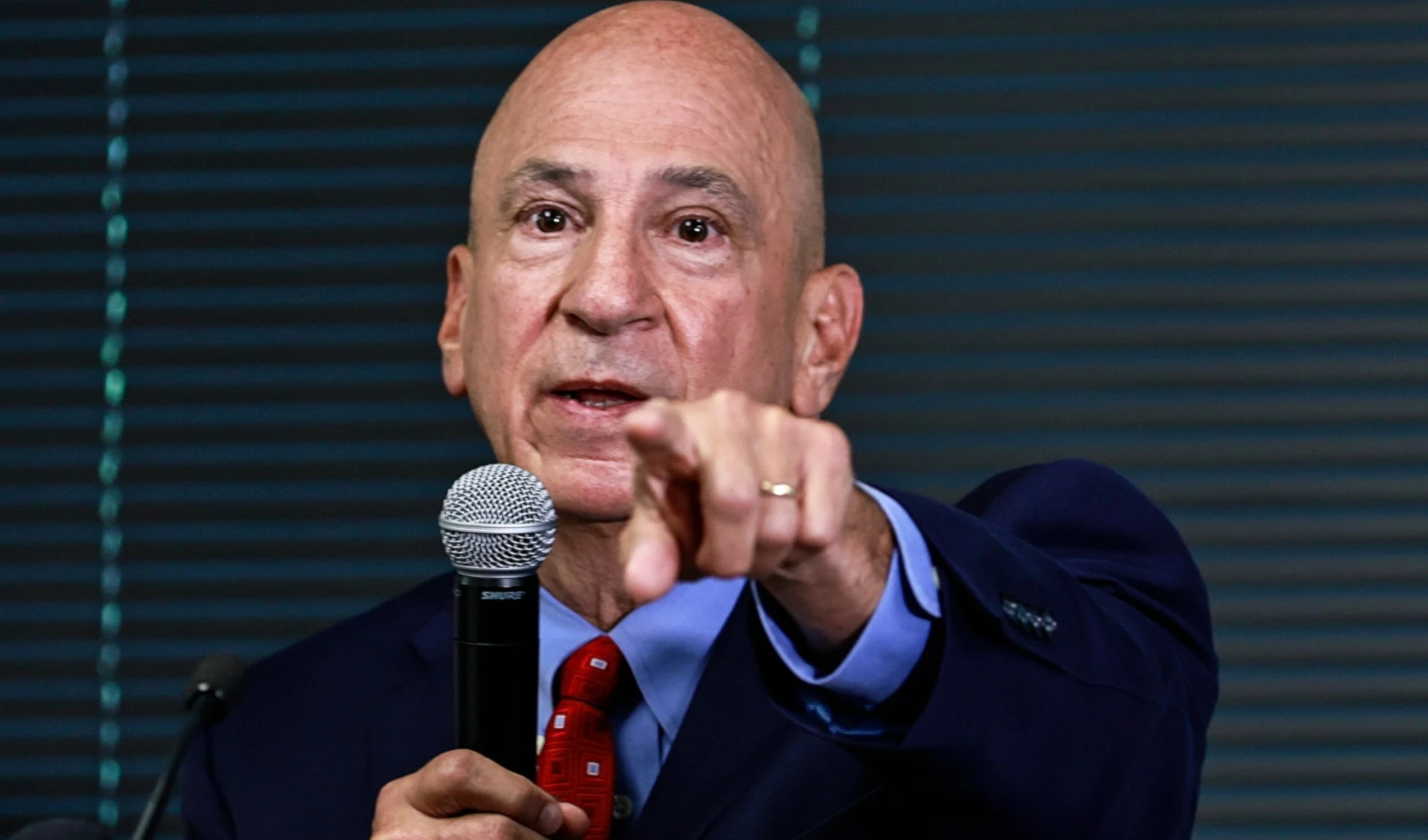 Peter J. Skandalakis speaks during a press briefing, pointing toward attendees while addressing questions about the Georgia election-interference case.