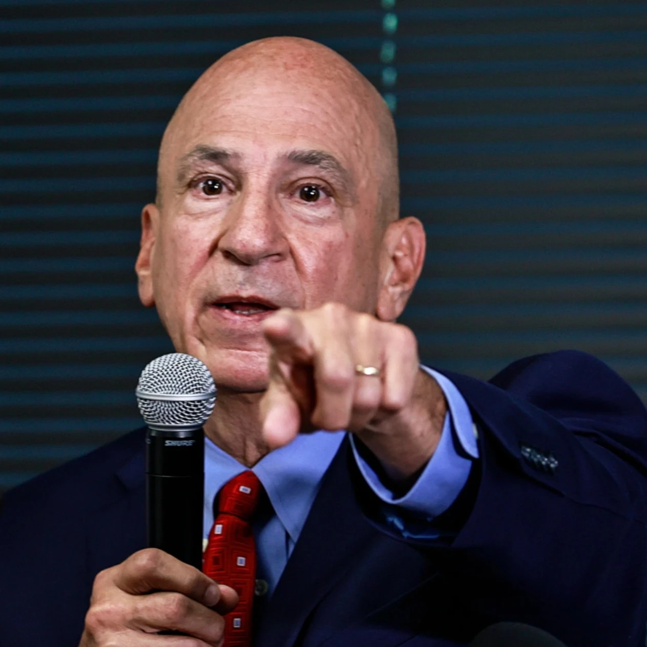 Peter J. Skandalakis speaks during a press briefing, pointing toward attendees while addressing questions about the Georgia election-interference case.