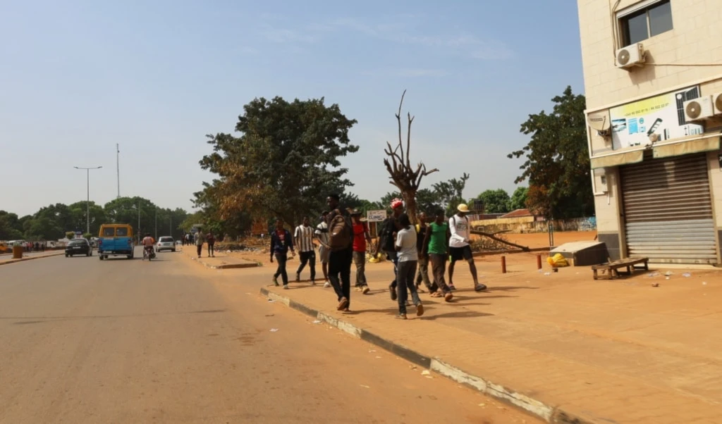 People walk on the street in Bissau, Guinea-Bissau, Wednesday, Nov. 26, 2025. (AP Photo/Darcicio Barbosa)