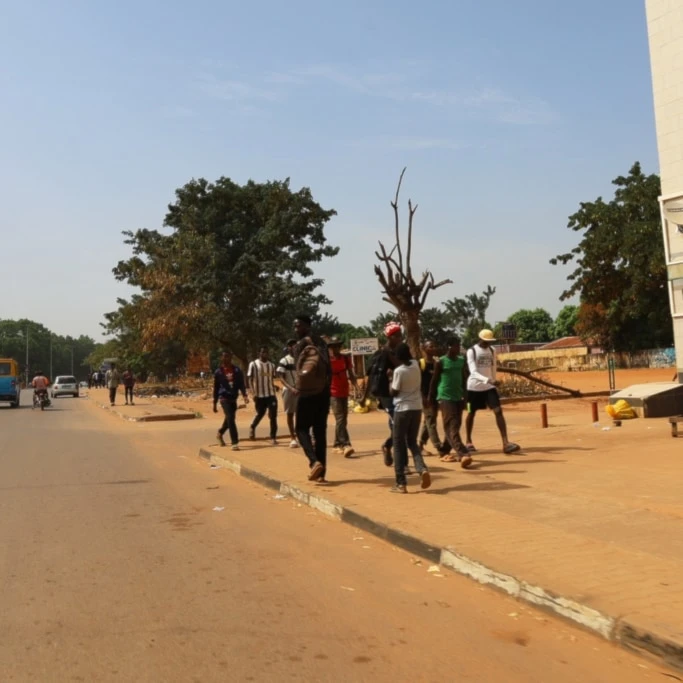 People walk on the street in Bissau, Guinea-Bissau, Wednesday, Nov. 26, 2025. (AP Photo/Darcicio Barbosa)