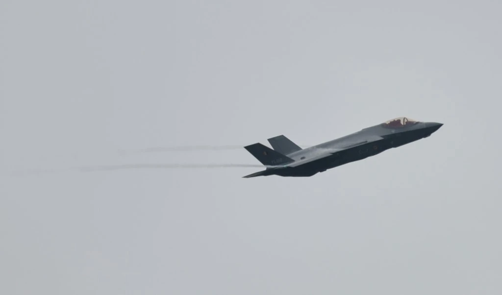 An F-35A Lightning II flys by on the occassion of the first F-35 fighter jets arriving at the Florennes Airbase in Florennes, Belgium, Monday, Oct. 13, 2025 (AP Photo/Geert Vanden Wijngaert)