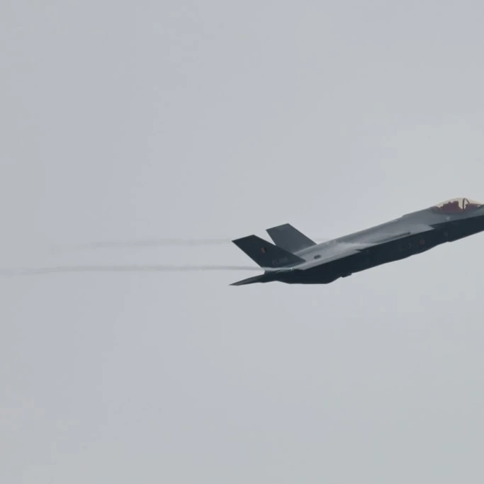 An F-35A Lightning II flys by on the occassion of the first F-35 fighter jets arriving at the Florennes Airbase in Florennes, Belgium, Monday, Oct. 13, 2025 (AP Photo/Geert Vanden Wijngaert)