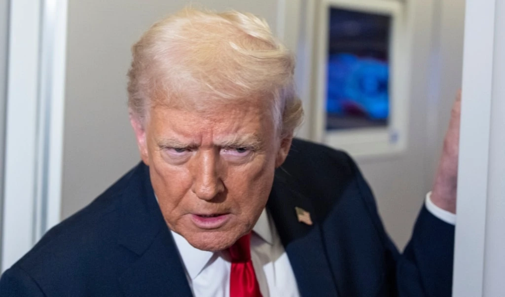 President Donald Trump leans in to hear a question as he speaks with reporters while in flight on Air Force One, Nov. 25, 2025. (AP)