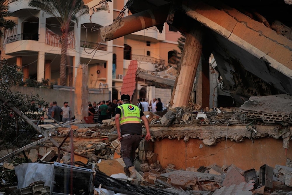 A civil defense member inspects the rubble of a building destroyed by an Israeli airstrike in the village of Teir Debba, southern Lebanon, Thursday, November 6, 2025 (AP)