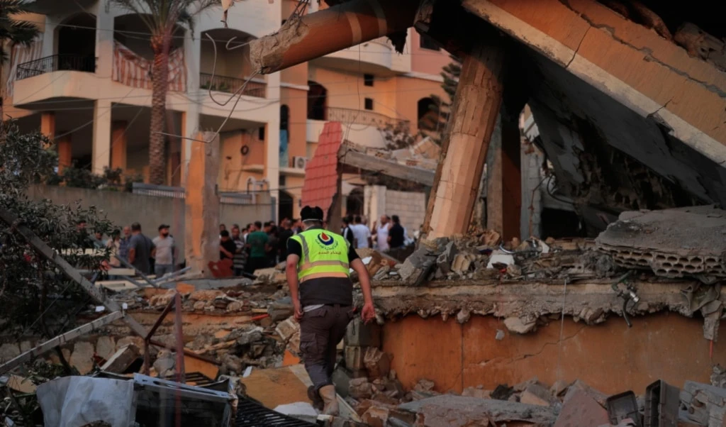 A civil defense member inspects the rubble of a building destroyed by an Israeli airstrike in the village of Teir Debba, southern Lebanon, Thursday, November 6, 2025 (AP)