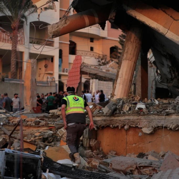 A civil defense member inspects the rubble of a building destroyed by an Israeli airstrike in the village of Teir Debba, southern Lebanon, Thursday, November 6, 2025 (AP)