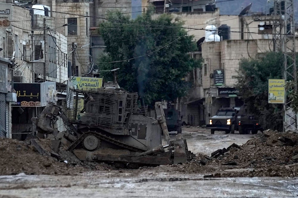 Israeli military bulldozers are seen during an Israeli military operation in the West Bank refugee camp of Jenin, on November 19, 2024. (AP Photo/Majdi Mohammed)