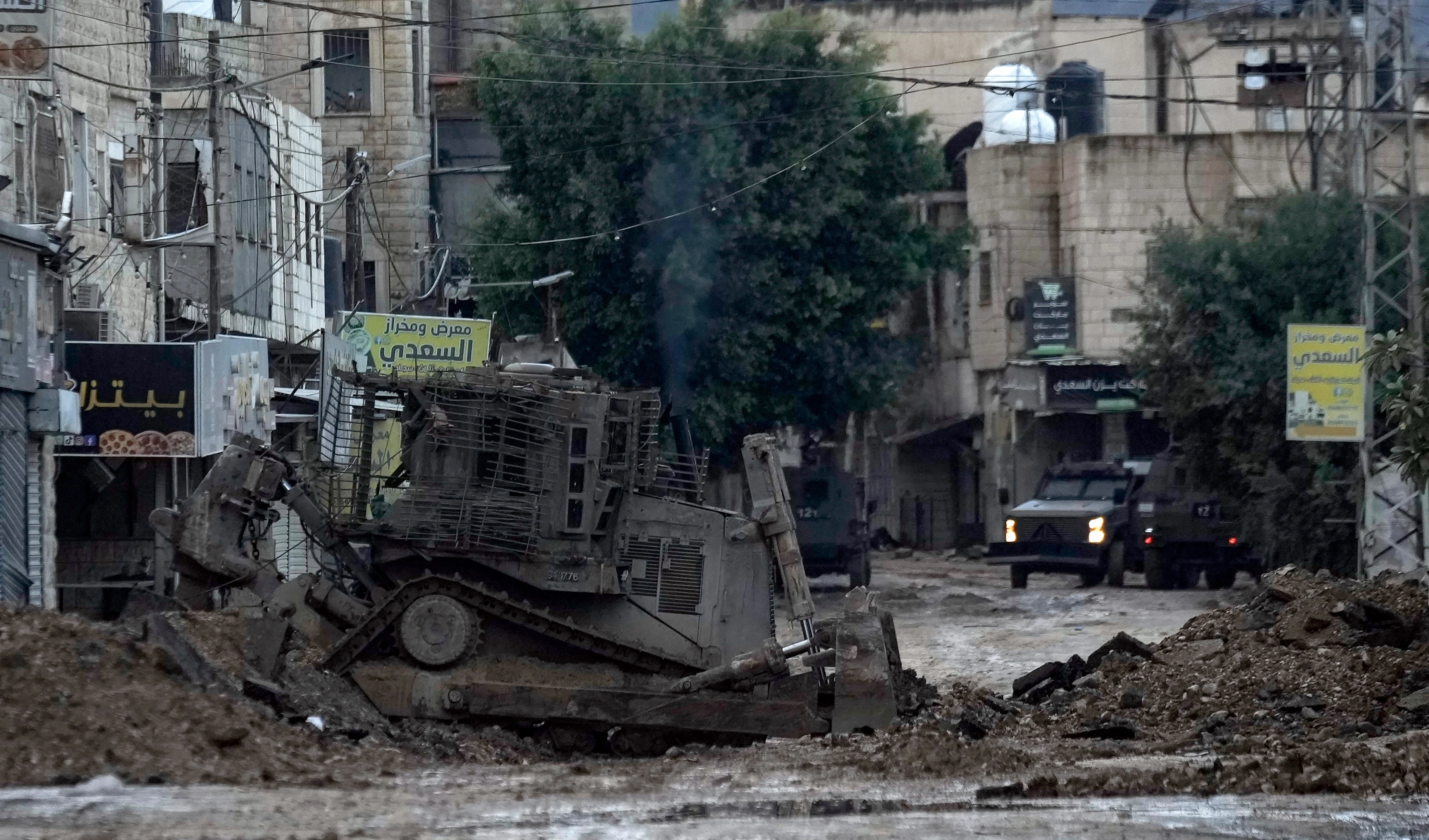 Israeli military bulldozers are seen during an Israeli military operation in the West Bank refugee camp of Jenin, on November 19, 2024. (AP Photo/Majdi Mohammed)