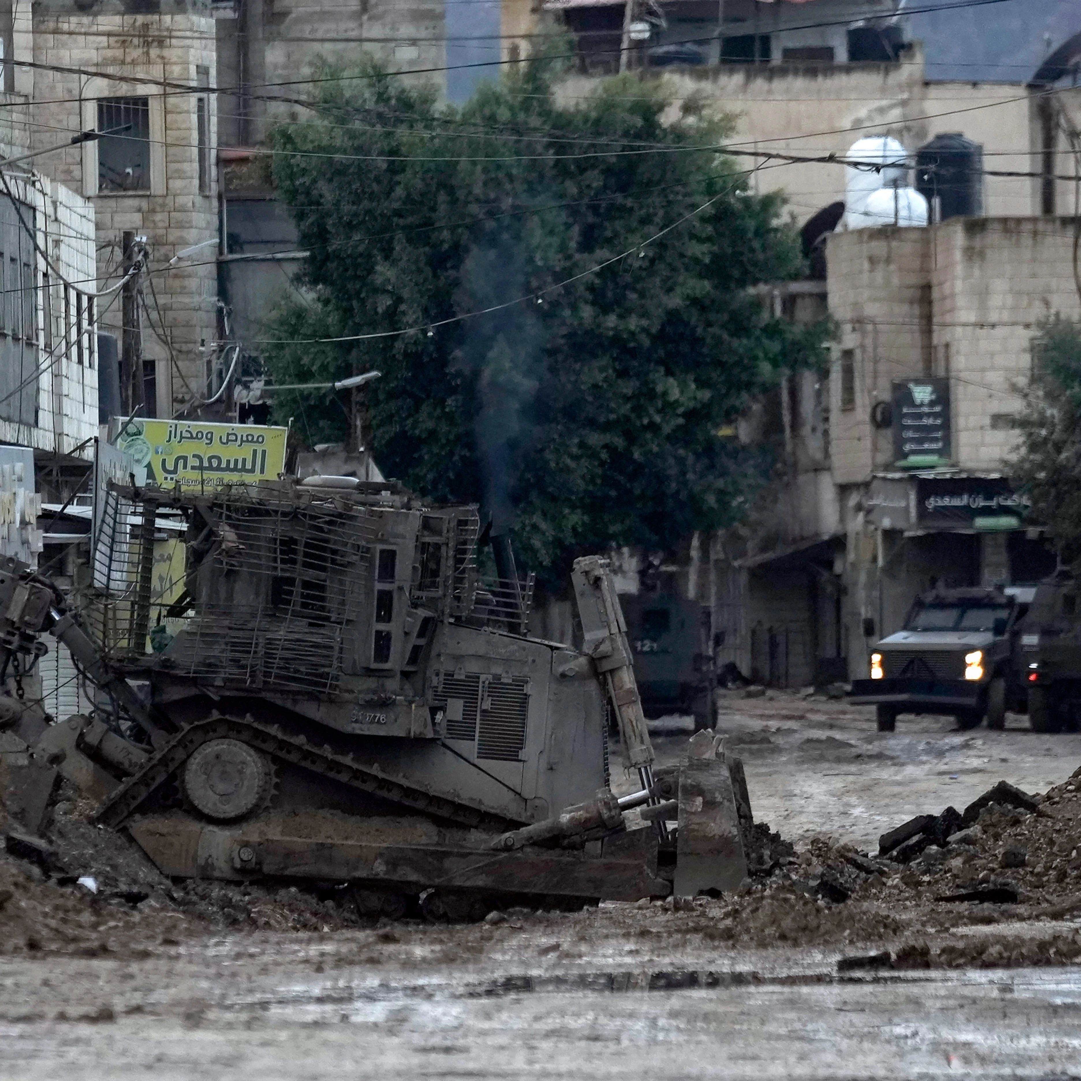 Israeli military bulldozers are seen during an Israeli military operation in the West Bank refugee camp of Jenin, on November 19, 2024. (AP Photo/Majdi Mohammed)
