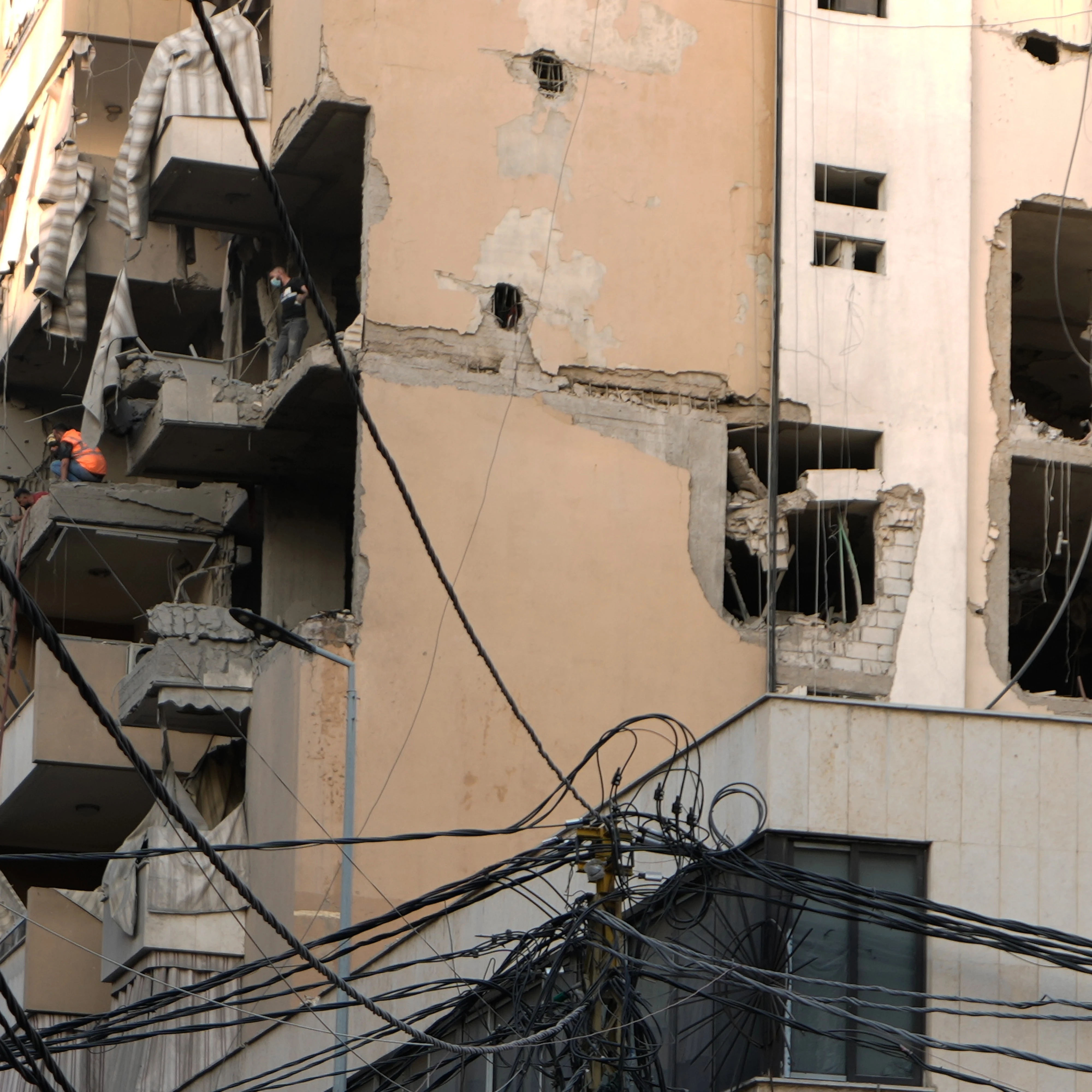 Civil defense workers inspect the damage after an apartment building was hit during an Israeli airstrike on Dahiyeh in the southern suburb of Beirut, Sunday Nov. 23, 2025 (AP)