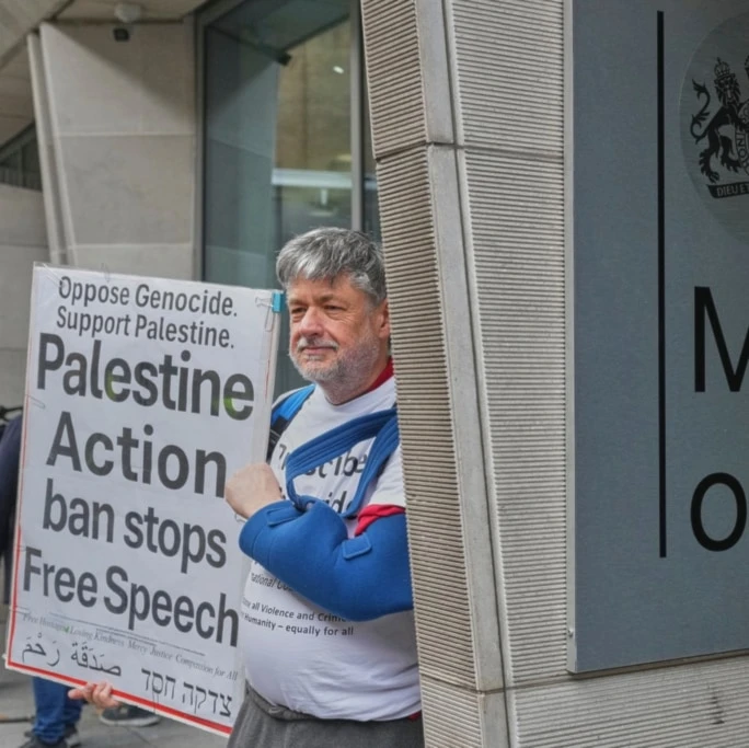 Protesters hold placards outside the Ministry of Justice during a Palestine Action demonstration in London, Thursday, November 20, 2025. (AP Photo/Frank Augstein)