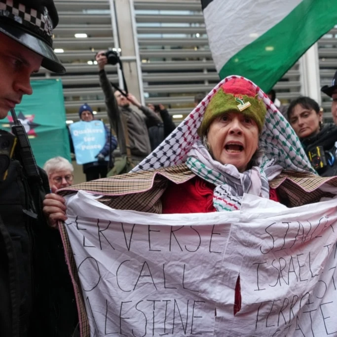 Police officers detain a protester outside the Home Office during a Palestine Action demonstration in London, Monday, November 24, 2025. (AP Photo/Kirsty Wigglesworth)