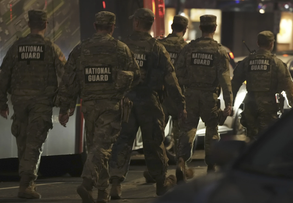   National Guard move through the area following the shooting of two National Guard soldiers near the White House on November 26, 2025 in Washington. (AP)