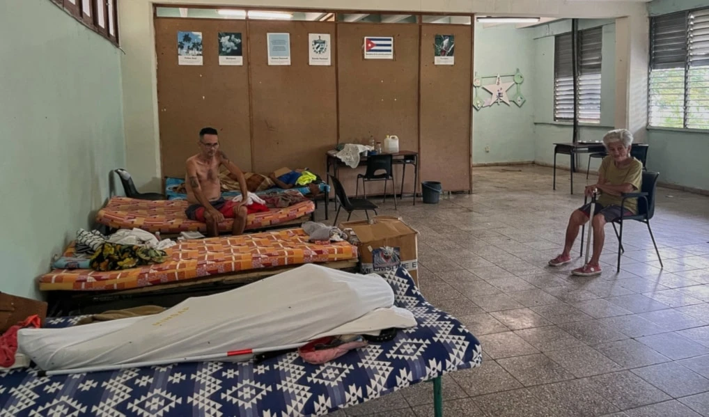 People displaced by Hurricane Melissa sit in a shelter in Los Mangos, Cuba, Monday, November 17, 2025. (AP Photo/Milexsy Duran)