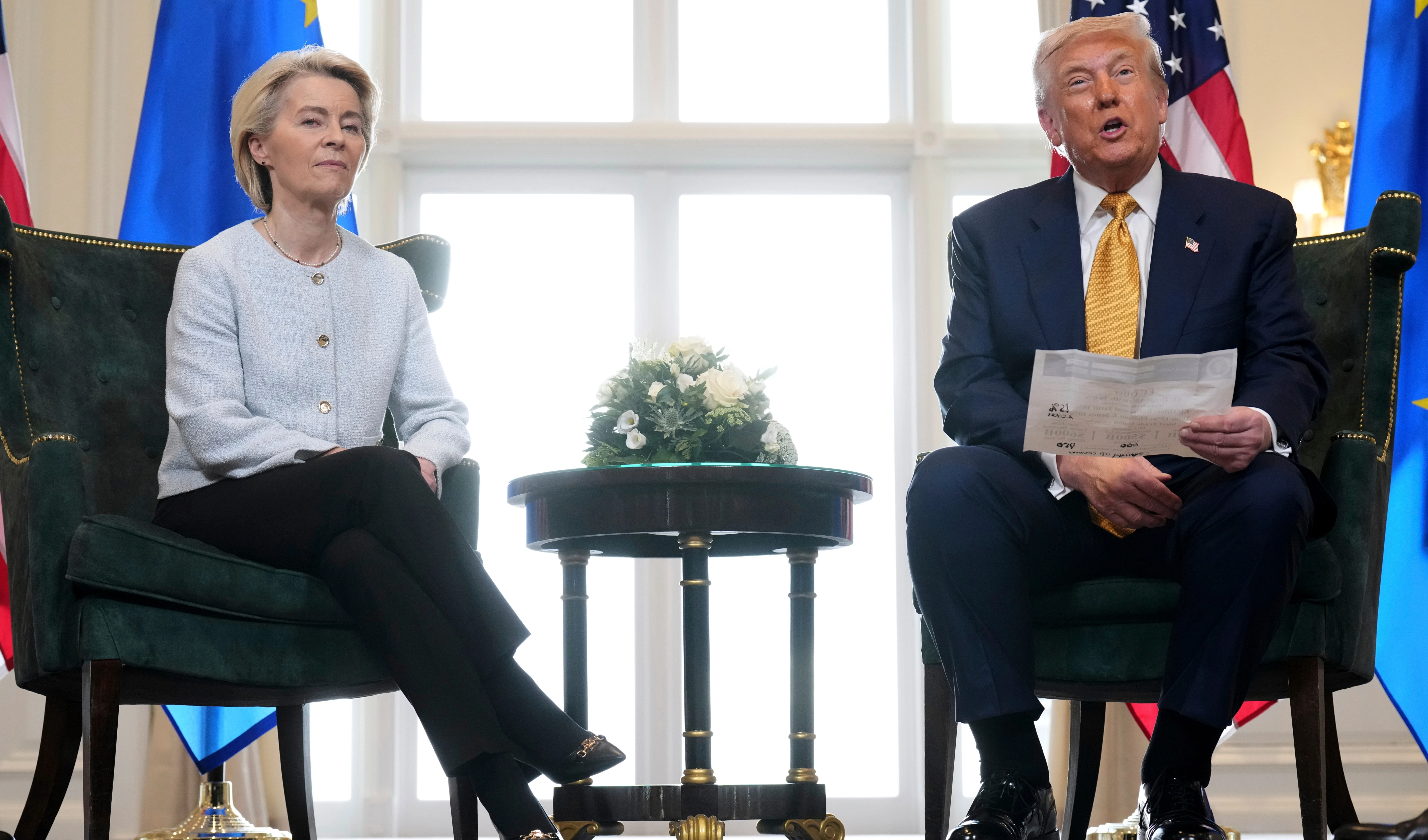 President Donald Trump reads from a paper and European Commission President Ursula von der Leyen listens after reaching a trade deal between the U.S. and the EU at the Trump Turnberry golf course in Turnberry, Scotland Sunday, July 27, 2025 (AP)