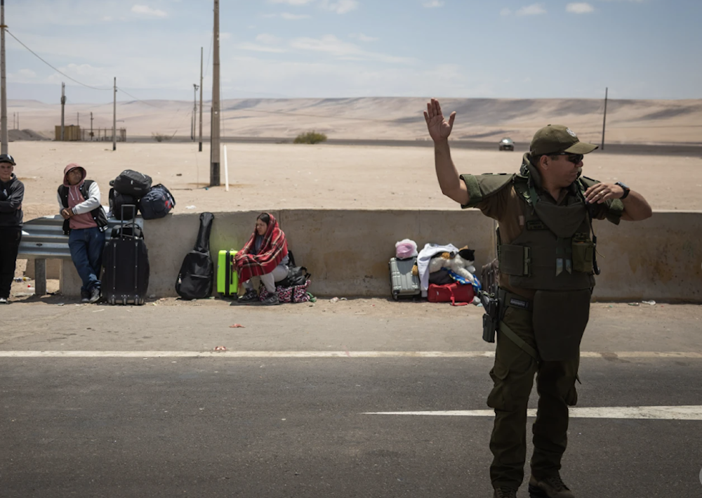 A police officer directs traffic at the Chacalluta border crossing point in Arica, Chile on November 28, 2025. (AP)