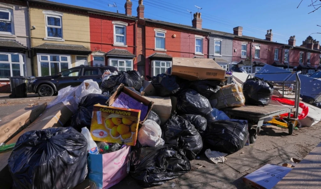 Rubbish piles up on a residential street in Birmingham, England, Monday, April 7, 2025, amid an ongoing refuse workers' strike in the city. (AP Photo/Kirsty Wigglesworth)